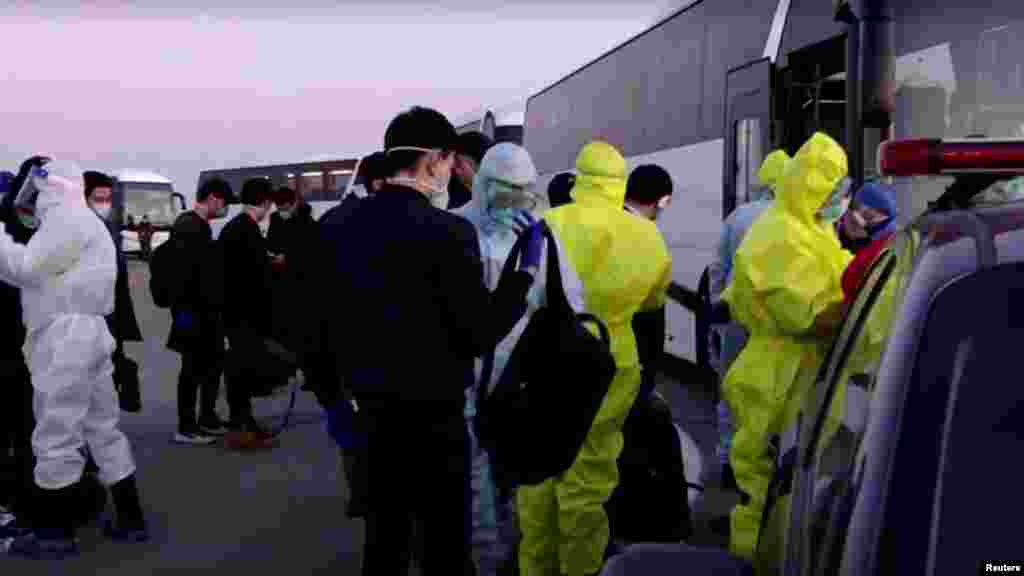 A video grab shows Uzbek citizens, mainly students, on their arrival from China at the airport in Tashkent.