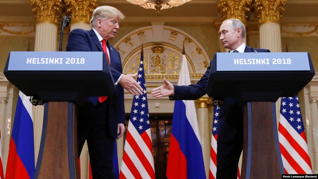 U.S. President Donald Trump (left) and Russian President Vladimir Putin shake hands during a joint news conference after their meeting in Helsinki on July 16.