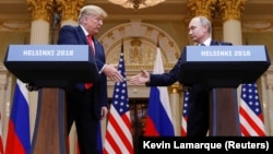 U.S. President Donald Trump (left) and Russian President Vladimir Putin shake hands during a joint news conference after their meeting in Helsinki on July 16.