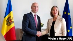 European Union foreign policy chief Federica Mogherini greets Moldovan Prime Minister Pavel Filip prior to their meeting in Brussels on May 3. 