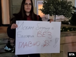  Млада жена държи афиш по време на митинга в Ямбол във вторник вечерта. 