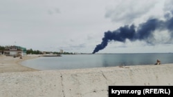 Smoke rises from an oil depot in Feodosia in Crimea after a reported drones attack on May 30. 
