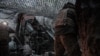 Ukrainian soldiers operate an M777 howitzer.