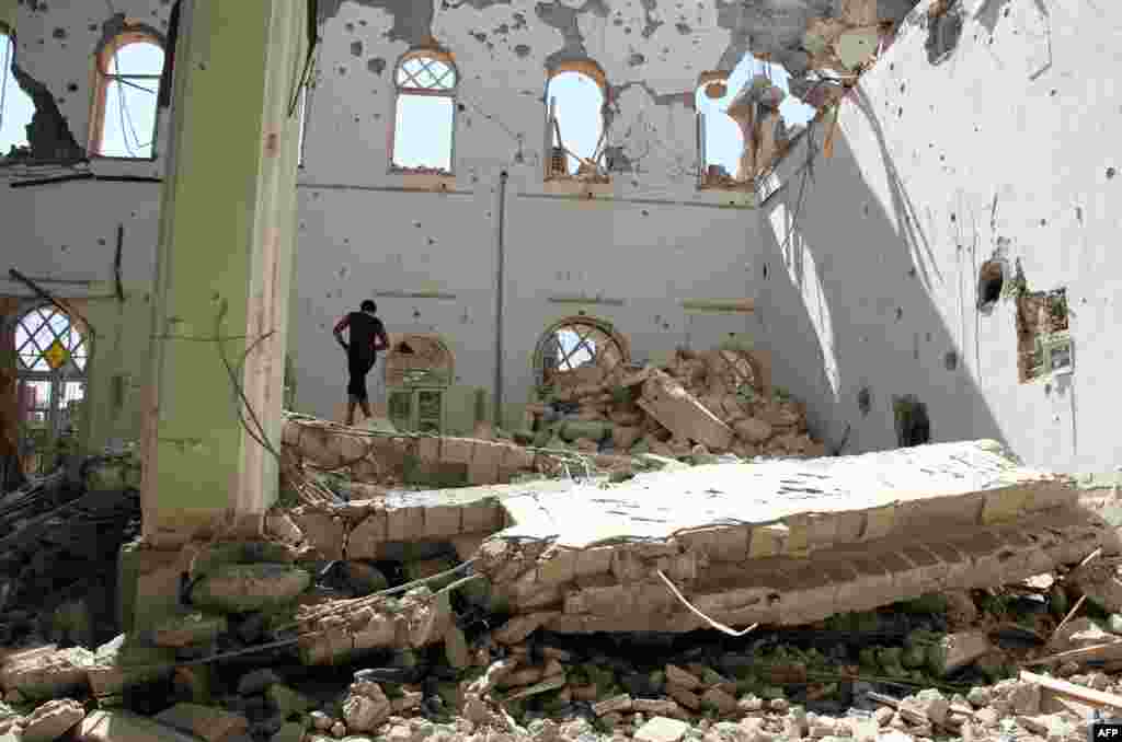 A man stands amid the rubble of the Othman mosque in the eastern Syrian town of Deir Ezzor. (AFP/Karam Jamal)