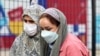 Жени носат маски за да се заштитат од загадувањето на воздухот во Техеран на 29 ноември