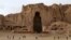 Afghan boys play soccer in front of the empty seat of one of two Buddha statues destroyed by the Taliban in 2001 in Bamiyan Province.