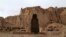 Children play soccer in front of the empty seat of one of two Buddha statues in Bamiyan province, which was destroyed by the Taliban in 2001.
