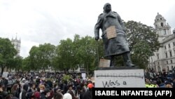 Statuia fostului prim-ministru britanic Winston Churchill cu inscripția [Churchill] „a fost rasist” scrisă pe soclu, în Piața Parlamentului din centrul Londrei, după o demonstrație în fața ambasadei Statelor Unite, 7 iunie 2020.