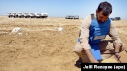 A member of a Halo Trust team shows a landmine, allegedly planted by the mujahedin during the war against the Soviets, in Kohsan district of Herat Province in 2010.