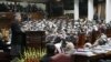 Afghan President Hamid Karzai (standing) addresses the Afghan parliament in February 2010.