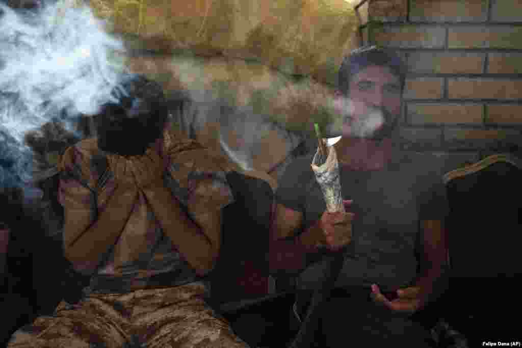 Kurdish men smoke a water pipe in central Irbil, Iraq. (AP/Felipe Dana)