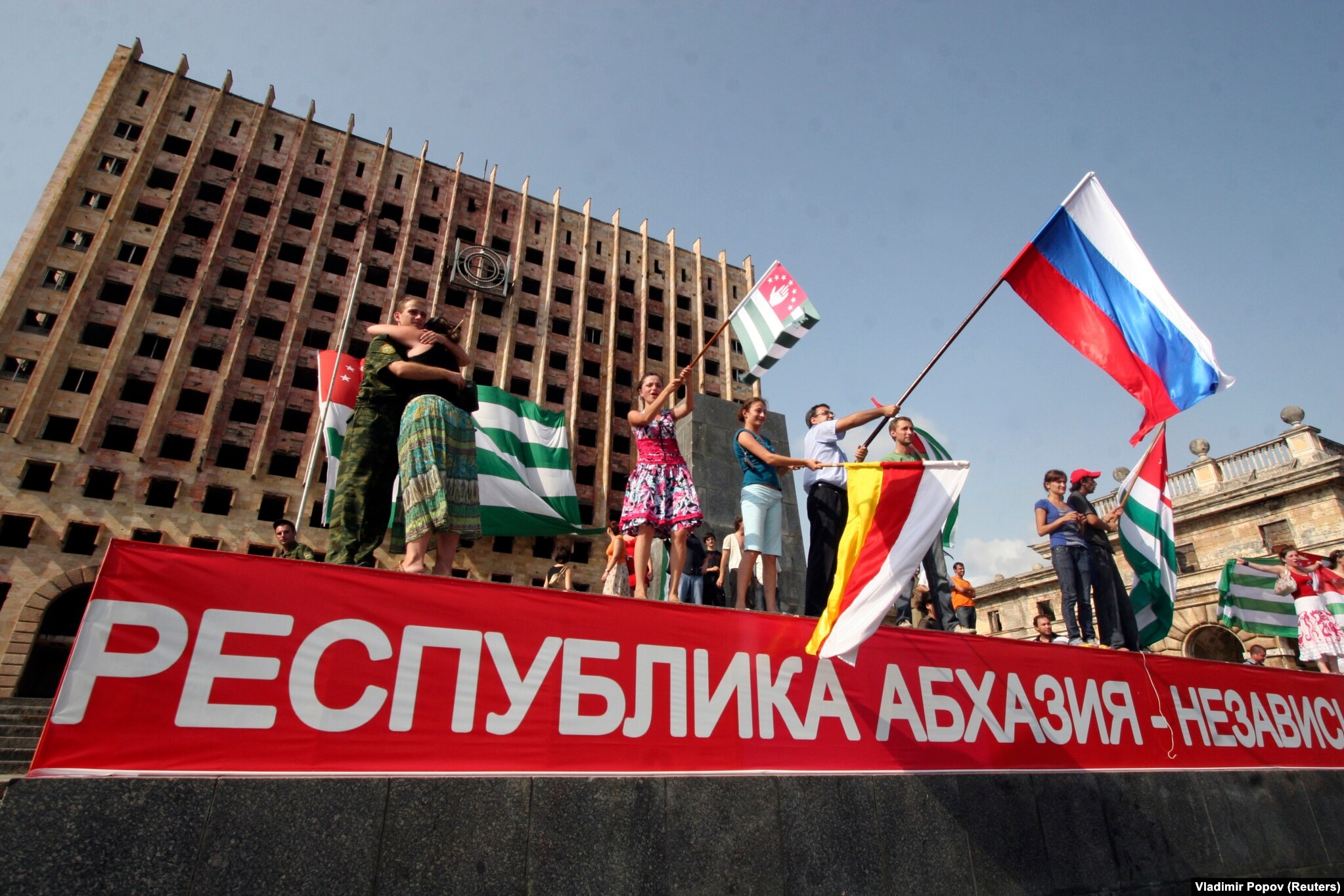 In the first major crisis of Medvedev's presidency, Russia fought a five-day war with Georgia over the breakaway Georgian territories of Abkhazia and South Ossetia. In this photo from August 26, 2008, people in Sukhumi wave flags as they celebrate Moscow's recognition of the territories as independent states. 