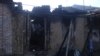 Разрушенный и сожженный дом родственников боевика в чеченском селе Янди