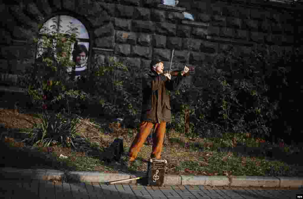 A blind elderly man plays the violin as he tries to drum up some money in downtown Kyiv, Ukraine. (epa/Roman Pilipey) 