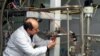 An IAEA inspector checks the enrichment process inside the uranium enrichment plant Natanz, January 20, 2014