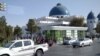 Turkmenistan. Mosque in Mary city. Cars on the road. People waiting for the bus or taxi. November 2020
