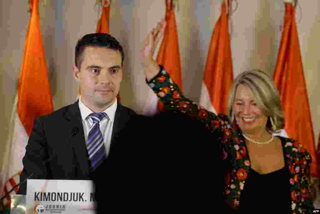 Gabor Vona (left), the chairman of Hungary's far-right Jobbik (Better) party, and party colleague Krisztina Morvay speak in Budapest. The party won some 15 percent of the vote.