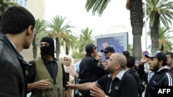 People demonstrate in front of the headquarters of the private TV station Nessma in Tunis on October 9.