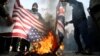 Demonstrators burn the U.S. and British flags during a protest in Tehran after the killing of General Soleimani.