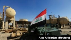 An Iraqi flag is seen on a military vehicle at an oil field in Dibis area on the outskirts of Kirkuk, October 17, 2017