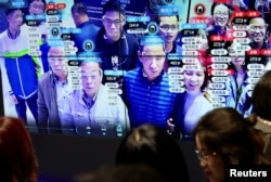 Visitors are seen at a screen displaying facial recognition technology at the Digital China Exhibition in Fuzhou, Fujian province, China. (file photo)