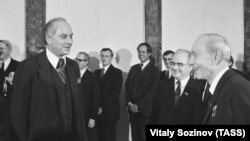 U.S. Ambassador to the Soviet Union Arthur A. Hartman (left) presents his credentials to Politburo member Vasily Kuznetsov in 1981. 