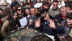 Armenia - A police officer tries to stop environmental activists pitching a tent in Yerevan's Mashtots Park, 13Mar2012.