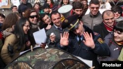 Armenia - A police officer tries to stop environmental activists pitching a tent in Yerevan's Mashtots Park, 13Mar2012.