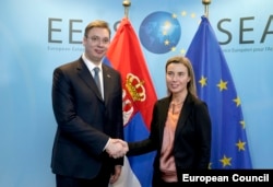 Serbian Prime Minister Aleksandar Vucic with the EU's foreign policy chief, Federica Mogherini. Failure to hand Seselj over to the ICTY may pose an obstacle to Serbia's European-integration ambitions.