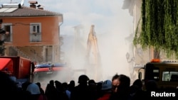 Dust rises from the rubble of the Italian town of Amatrice following an aftershock from a deadly earthquake that has killed hundreds of people. 