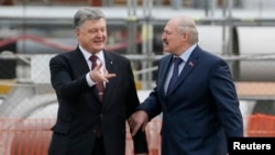 The presidents of Ukraine, Petro Poroshenko (left), and Belarus, Alyaksandr Lukashenka, attend a commemoration ceremony marking the anniversary of the nuclear disaster at the Chernobyl nuclear power plant in Ukraine on April 26.