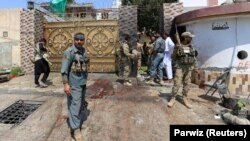 Afghan security forces stand at the site of a suicide attack in the city of Jalalabad on August 30.