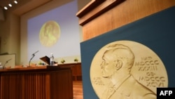 Медаль с изображением премии Альфреда Нобеля, шведского ученого, завещавшего свое состояние на учреждение премий за достижения в физике, химии, медицине, литературе и за деятельность по укреплению мира. 