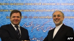 Iranian Foreign Minister Ali Akbar Salehi (right) and Russian Energy Minister Sergei Shmatko shake hands after signing an energy memorandum of understanding in Tehran in September 2011.