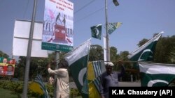 Pakistani and Kashmiri flags are displayed around Lahore, Pakistan, ahead of nationwide anti-India protests.
