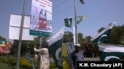 Pakistani and Kashmiri flags are displayed around Lahore, Pakistan, ahead of nationwide anti-India protests. 