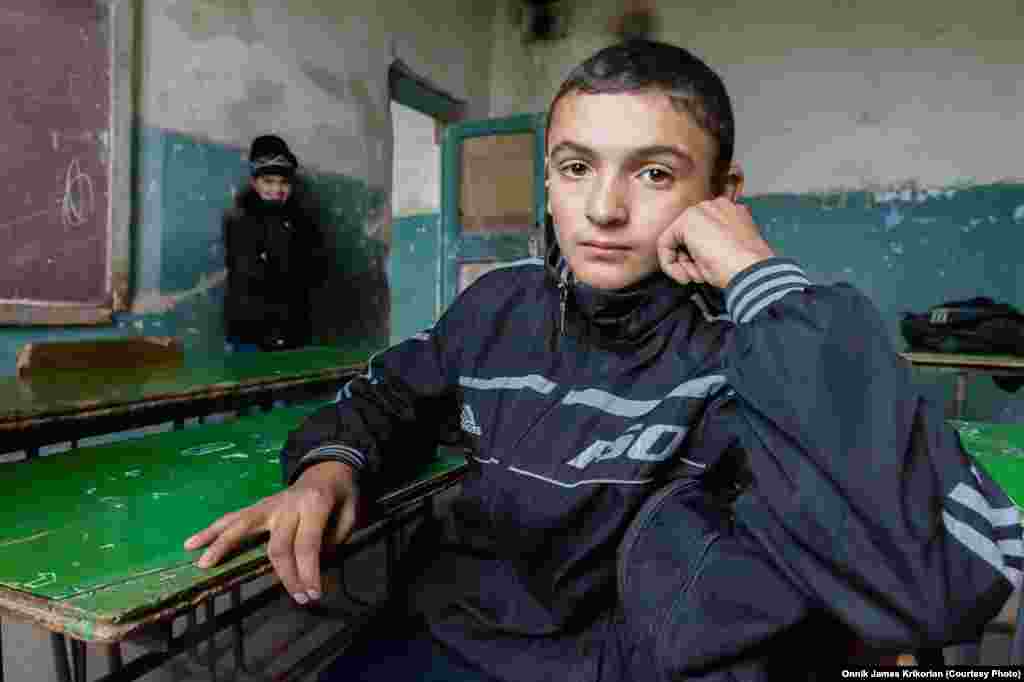 An ethnic Armenian pupil in a dilapidated classroom. Students and teachers are waiting for the Georgian government to fulfill its promises to help repair the school.