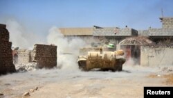 IRAQ -- A tank of Iraqi army fires against Islamic State militants at Al Jazeera neighbourhood of Tal Afar, August 23, 2017