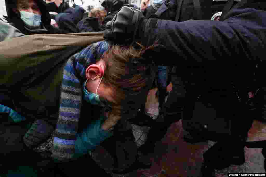 Police detain a protester in Moscow.