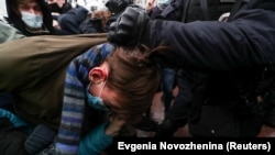 Police detain a protester in Moscow.