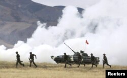 Kyrgyzstan -- Servicemen take part in the Collective Security Treaty Organisation (CSTO) military exercises outside Bishkek, 21Sep2011