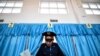 A Kazakh policeman votes during parliamentary elections in the Kazakh city of Baikonur on March 20. (AFP/Kirill Kudryavtsev)