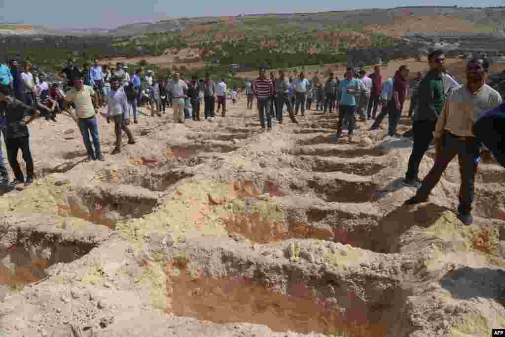 People wait next to empty graves during funerals for victims of a suicide attack on a wedding party that left 51 dead in Gaziantep in southeastern Turkey on August 21. Turkish President Recep Tayyip Erdogan said Islamic State was the "likely perpetrator" of the bomb attack, the deadliest in 2016. (AFP/Ilyas Akengin)