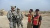 A member of the Sons Of Iraq (right) mans a checkpoint with a policeman in Samarra. 