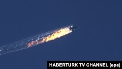 A still image from video footage shows a burning trail as the Russian jet crashes after being shot down near the Turkish-Syrian border.