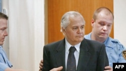 Milutinovic entering the Hague courtroom before the trial began