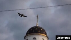 A grab from a YouTube video purporting to show Swede Tomas Mazetti in an airplane over Belarus dropping pro-free speech teddy bears on July 4.