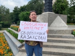 An activist holds a placard reading "Internet Freedom--Freedom in Kazakhstan' against what she called the government’s attempt to restrict the freedom of Internet users, in Nur-Sultan in July.