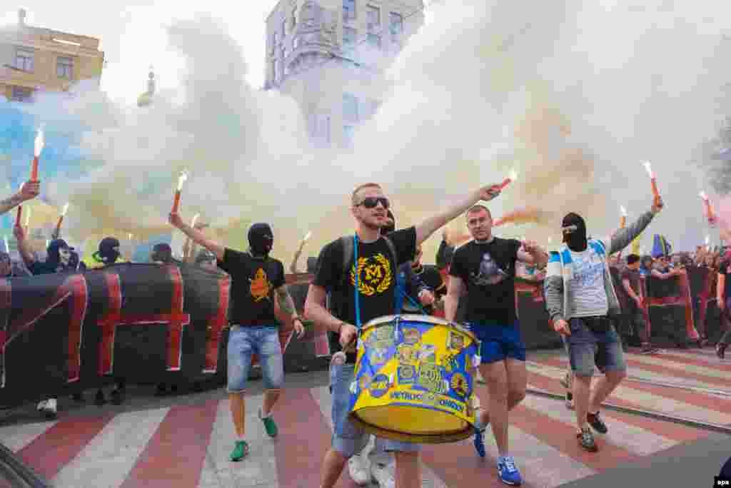 Fans of the Ukrainian soccer clubs Metalist and Dnipro,who are normally implacable enemies, gather during a march to support a united Ukraine in Kharkiv on April 27. (epa/Olga Ivashchenko) 