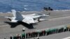 Sailors line up and watch Capt. William R. Reed, commander of Carrier Air Wing (CVW) 7, launch from the flight deck of the Nimitz-class aircraft carrier USS Abraham Lincoln in Arabian Sea, May 30, 2019. 